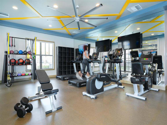a woman exercising in a gym with weights and cardio equipmentat Portofino Cove, Fort Myers, FL