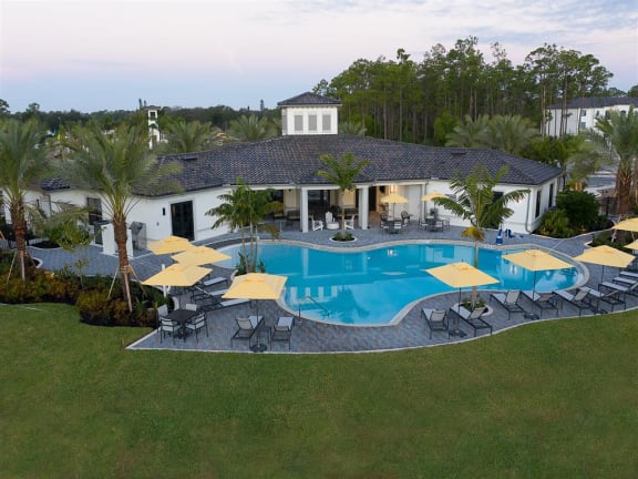 a large swimming pool in front of the clubhouse