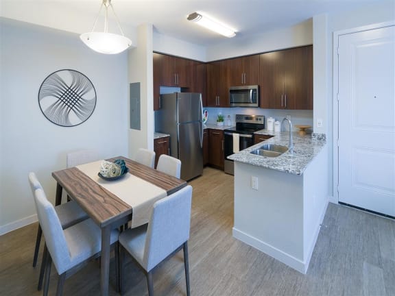 a kitchen and dining room with a table and chairs