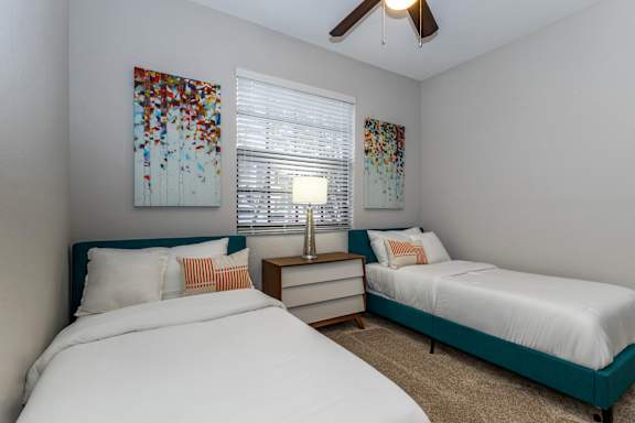 Bedroom with two beds and ceiling fan at Portofino Cove, Florida