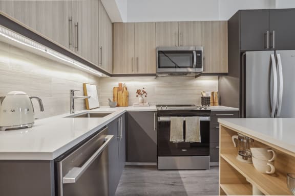 a kitchen with stainless steel appliances and white counter tops
