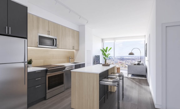a kitchen with an island and stools in a 555 waverly unit