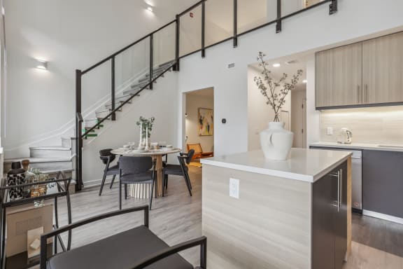 a kitchen with a dining area and a spiral staircase