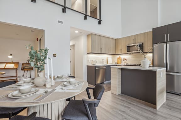 an open kitchen and dining room with a table and chairs