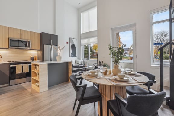 an open kitchen and dining room with a table and chairs
