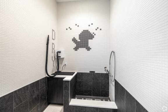 a bathroom with a tub and a shower and a pixelated wall
