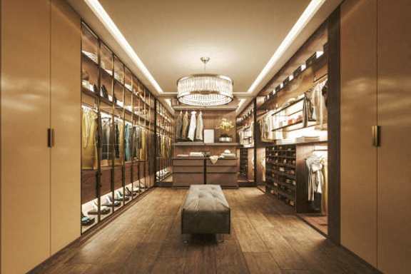 a walk in closet with a bench and a chandelier