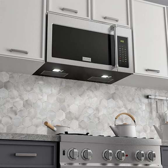 a kitchen with a stove and a microwave above it