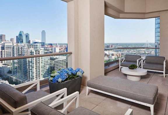 a balcony with a view of the city and the ocean