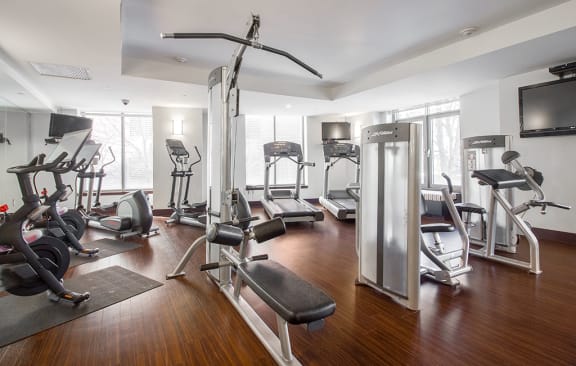 a gym with various exercise machines and a tv  at HIGHGROVE, Connecticut