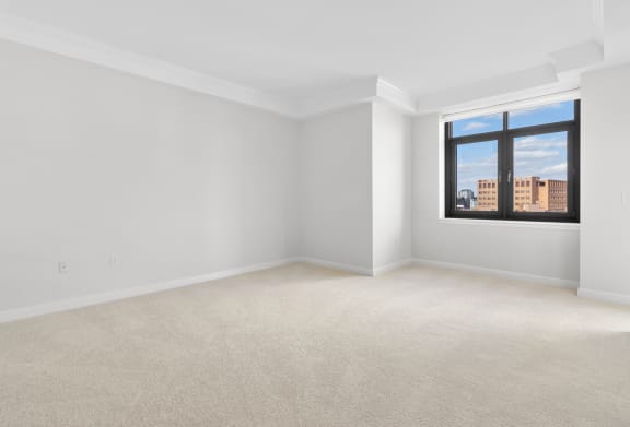 the living room of an empty apartment with a window at HIGHGROVE, Stamford, 06901