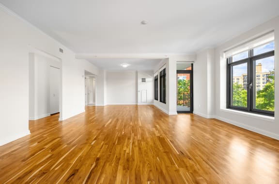 a living room with a hard wood floor and large windows at HIGHGROVE, Connecticut