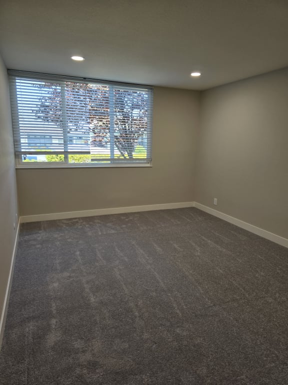 an empty living room with a large window