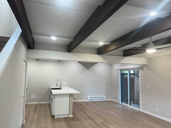 A kitchen with a white countertop and a white fridge.