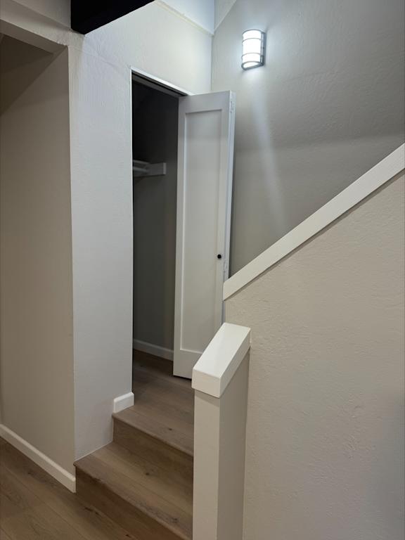 A white door is at the end of a staircase.