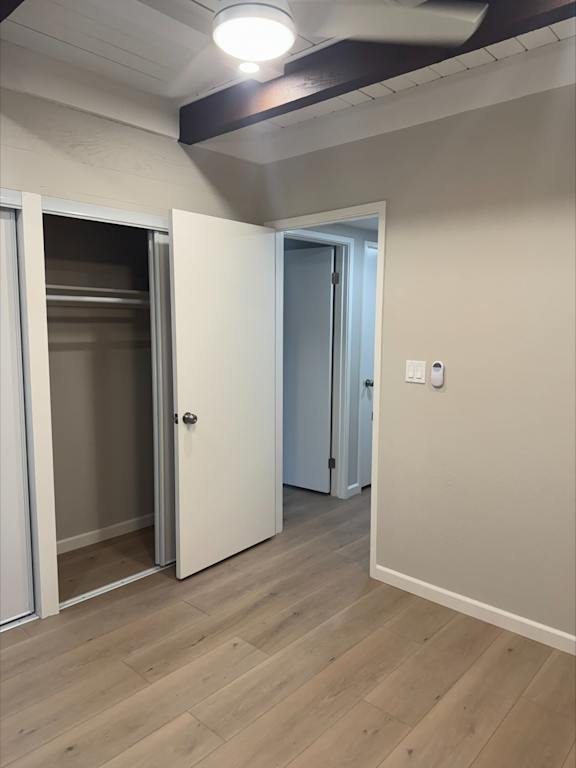 A room with a white door and a white wall with a switch.