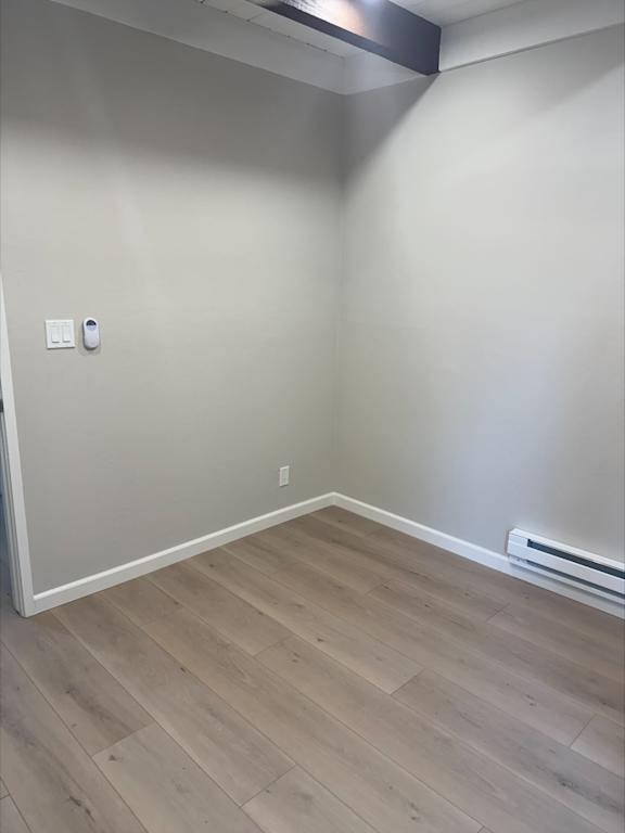 A room with a light switch and a wall socket.