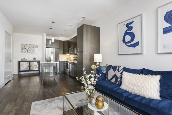 a living room with a blue couch and a glass table