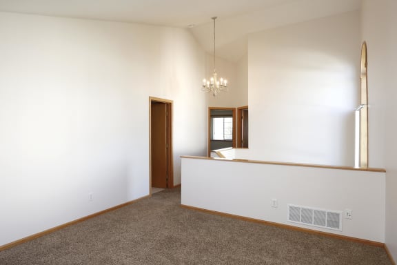 Interior of Avalon Cove Townhomes featuring an upstairs living area with vaulted 9-10 foot ceilings.