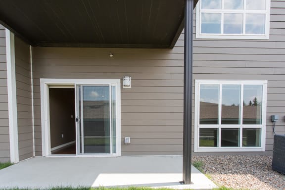 Outdoor patio with concrete platform, sliding glass door