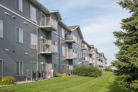Exterior of the Gardens Apartments, visible balconies on units and landscaped grass below