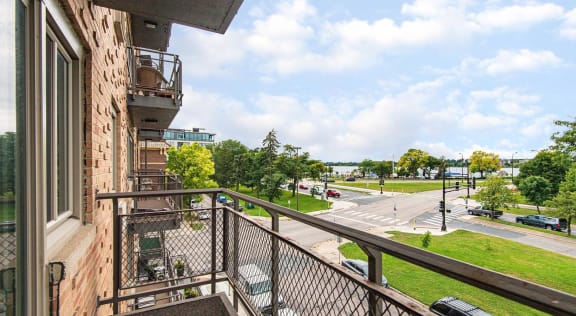 View of Lake Bde Maka Ska from private balcony with metal railing
