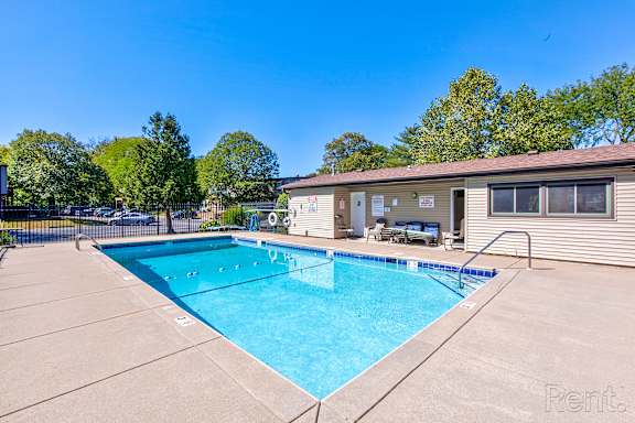 A swimming pool in a sunny backyard.