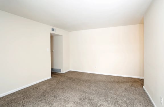 a bedroom with a carpeted floor and white walls