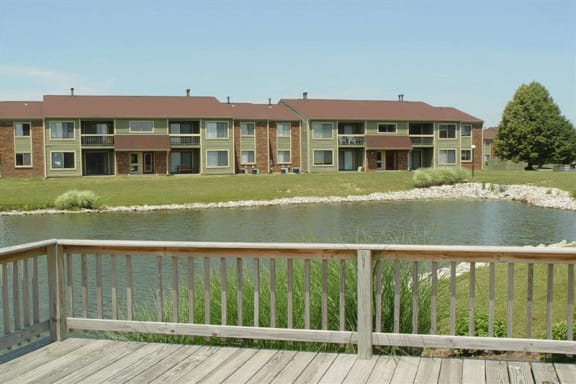 a view of a lake with an apartment complex in the background
