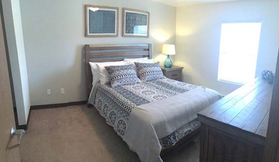 a bedroom with a bed and a dresser