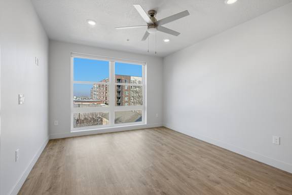 Room with shiny wooden floor and ceiling fan at Brickside Heights, Millcreek, 84106
