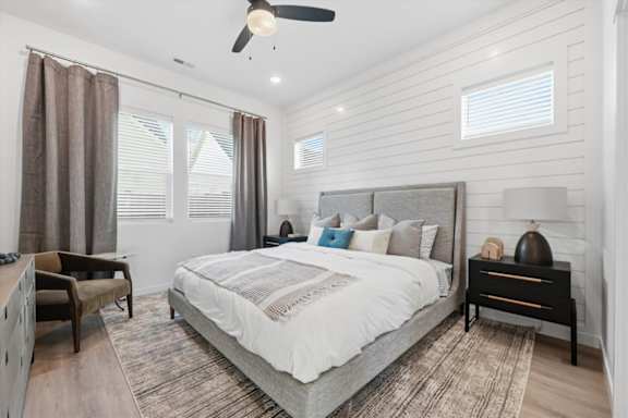 Bedroom with a large bed and oversized windows at Alante Homes at Spring Run, Caldwell, Idaho