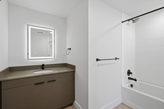 White Bathroom with Brown vanity1 at Brickside Heights, Millcreek, UT