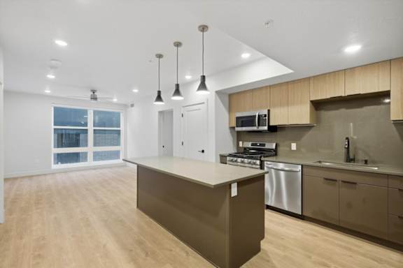 Bright kitchen and brown cabinetry4 at Brickside Heights, Millcreek, 84106