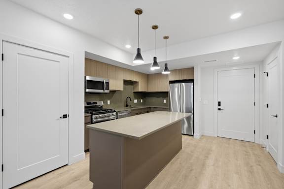Modern pendant lights in kitchen at Brickside Heights, Millcreek