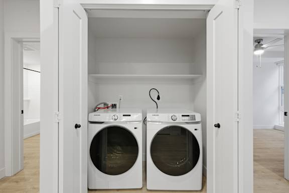 Two front loading machines in laundry room at Brickside Heights, Millcreek, Utah