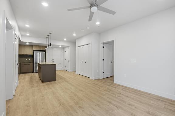 Spacious room and kitchen with ceiling fan at Brickside Heights, Millcreek