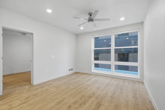 Room with ceiling fan and large window at Brickside Heights, Millcreek, 84106
