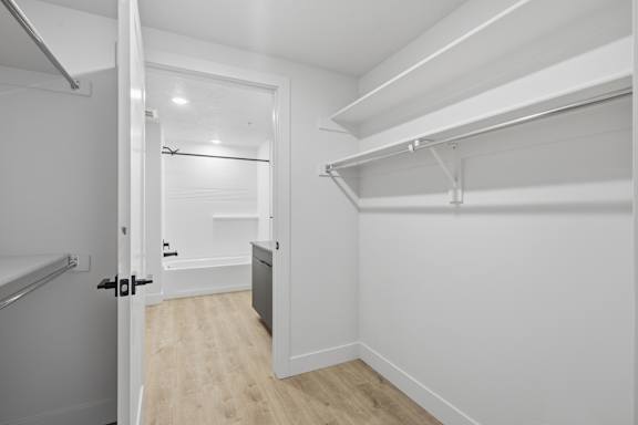 Large walk-in closet with bath attached at Brickside Heights, Utah