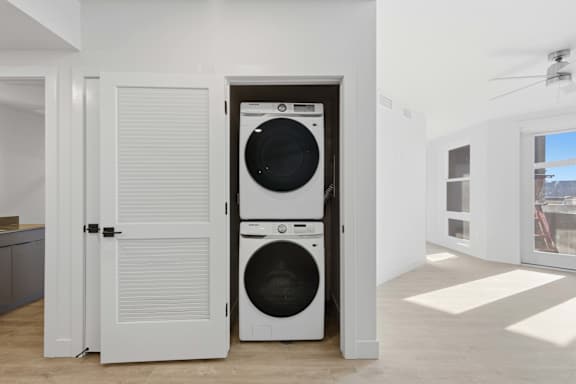 White laundry room with a washer and dryer in it at Brickside Heights, Millcreek, Utah
