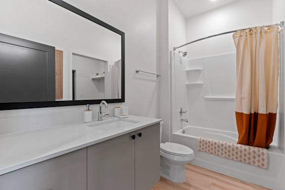 A bathroom with a white sink and a white toilet.
