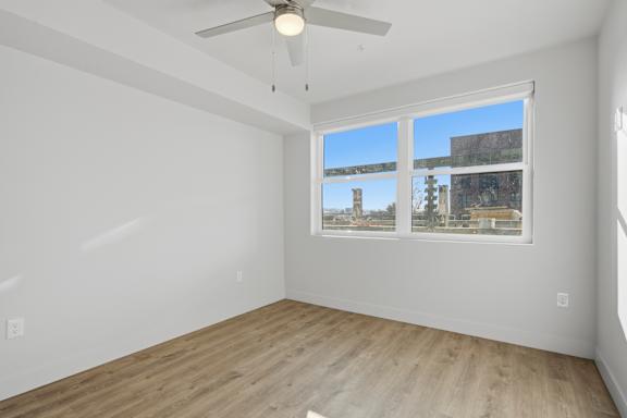 Empty room with window and ceiling fan at Brickside Heights, Millcreek, Utah