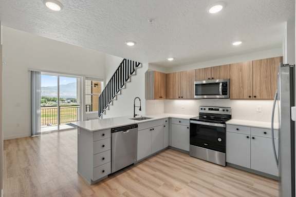 A modern kitchen with wooden cabinets and stainless steel appliances.