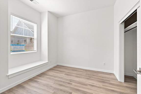 A room with a window and a door.