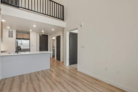A kitchen area with a counter and a fridge.