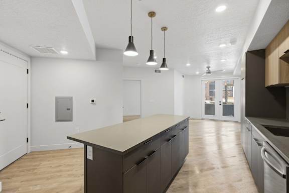 Kitchen with Wooden Cabinets and Large Island at Brickside Heights, Millcreek
