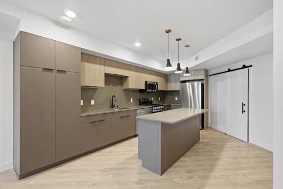 Kitchen with Wooden Cabinets at Brickside Heights, Millcreek, UT