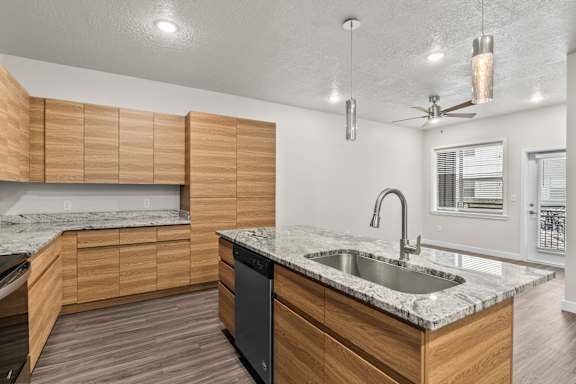 Kitchen with a counter at The Flats at Riverwoods, Provo, UT