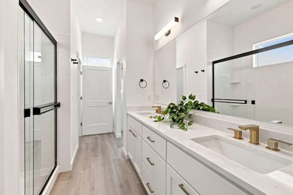 A bathroom with a white sink and a mirror.