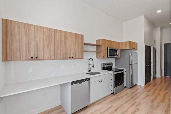 A kitchen with wooden cabinets and stainless steel appliances.